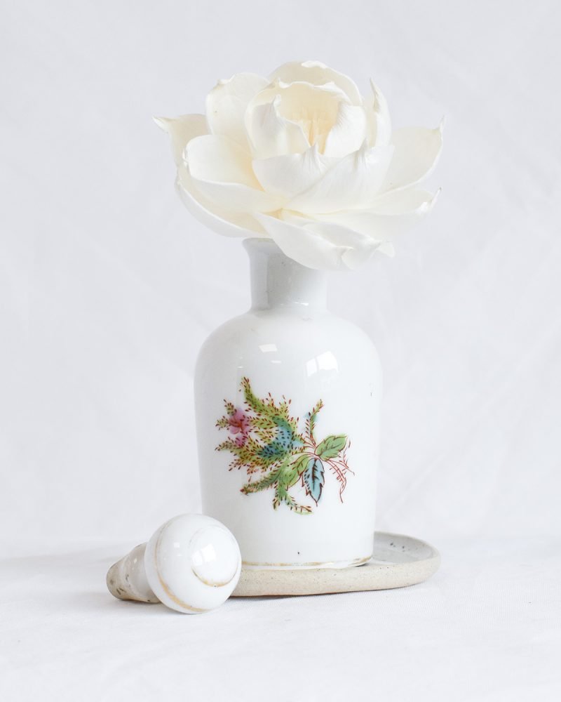 Antique French porcelain diffuser bottle with floral detail, handmade diffuser flower, and protective ceramic saucer