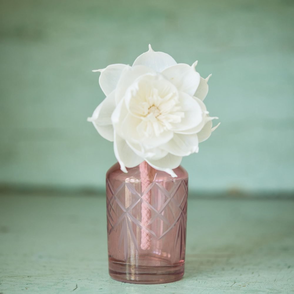 Pink glass diffuser bottle with white handmade diffuser flower