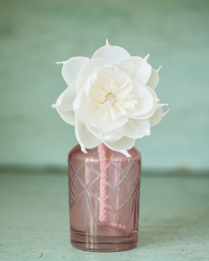 Pink glass diffuser bottle with white handmade diffuser flower