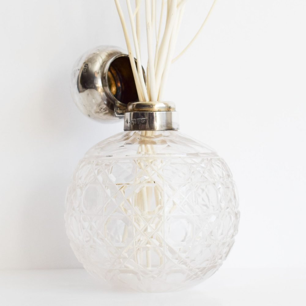 Detail of an Edwardian cut glass bottle with natural branched reeds